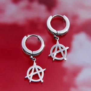 Macro shot of silver anarchy symbol earrings with punk rock style and polished finish