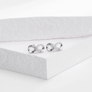 Detailed macro view of S925 sterling silver infinity stud earrings with sparkling cubic zirconia