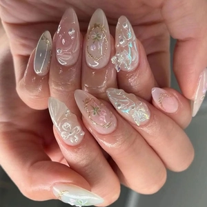 Elegant 3D almond press-on nails with pearls, pink flowers, and pearlescent white finish