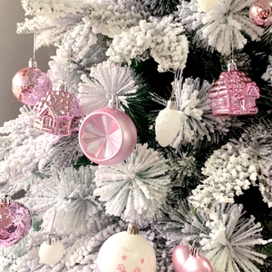 Pink and white Christmas tree ornaments including heart, house, and star shaped baubles