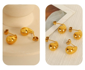 Macro detail of tear-drop earrings featuring 18K gold plated polished mirror finish