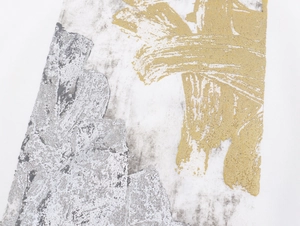 Detail showing metallic gold foil abstract print and grey marble texture on white fabric