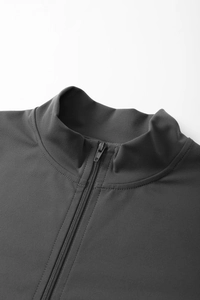 Macro detail of charcoal grey yoga jacket collar featuring a sleek half-zipper design