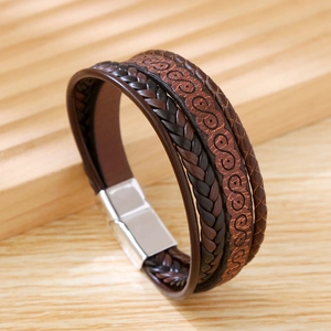 Detail of multi-layer leather bracelet with S-pattern embossing and silver metal clasp