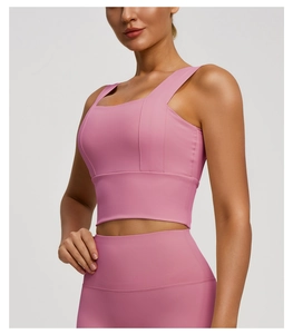Detail view of pink wide strap sports bra showing side fit and elastic fabric quality