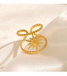Detail of 18K gold plated stainless steel starburst ring on white silk background