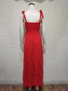 Detail of red polka dot sundress featuring smocked back and tiered skirt layers