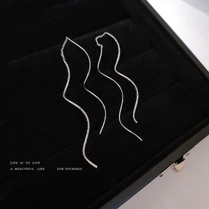Elegant silver-plated wave tassel threader earrings shown on a premium black velvet box