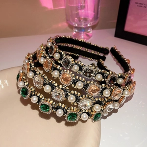 Detail view of colorful gemstones and pearls on premium black velvet padded headbands