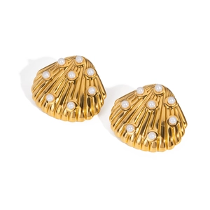 Detailed close-up of golden shell-shaped earrings with inlaid white pearls on white background