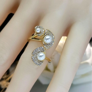 Elegant gold lotus-leaf ring with white pearls and zircon pavé on a model hand