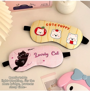 Close-up of cute cartoon puppy and cat sleep masks with elastic bands for rest