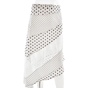 Detail view of white skirt with black polka dots, tiered lace and mesh fabric texture