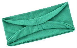 Close-up of mint green yoga headband with soft knit texture and twisted design