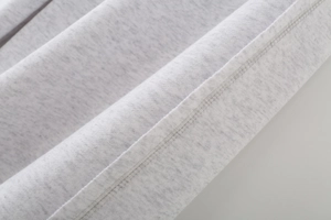 Macro shot of grey heather knit fabric showing soft texture and fine stitching detail