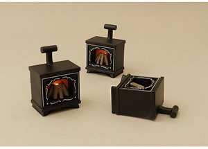 Detailed view of miniature glowing dollhouse fireplaces in black with realistic light effect