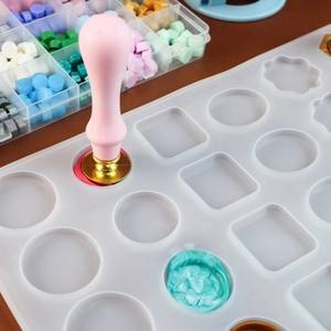 Detailed scene showing wax seal kit with silicone mold, metal stamps and colorful beads