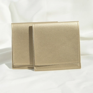 Close-up of dual gold PU leather drawstring pouches with premium textured surface