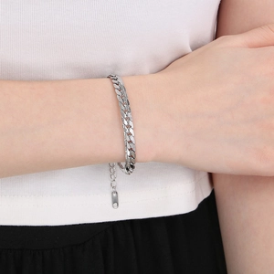Close-up of silver titanium steel NK Figaro chain bracelet on a model's wrist