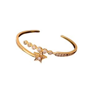 Gold plated star cuff bracelet with sparkling zircon stones in a minimalist luxury style
