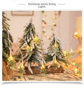 Detail view of warm LED Christmas tree string lights on a snowy background