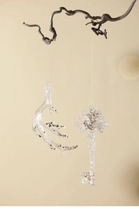 Close-up of transparent acrylic reindeer and snowflake key ornaments with silver sequins