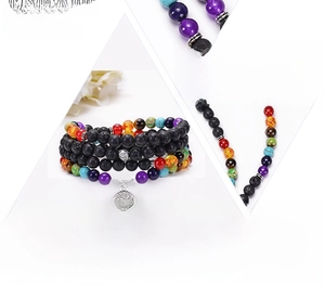 Macro shot of 108 lava beads bracelet with colorful natural stones and tree of life charm