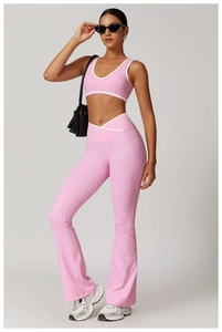 Detailed view of pink yoga set with white trim sports camisole and flared crossover leggings