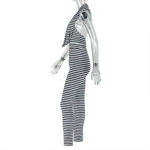 Side view detail of black and white striped halter jumpsuit with draped neckline design