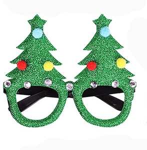 Macro view of green glitter Christmas tree glasses with pom-poms and rhinestones