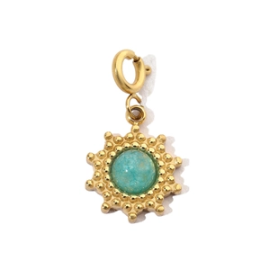 Detail of golden sunburst pendant with turquoise stone and spring ring clasp
