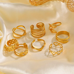8-piece set of gold-plated geometric heart and leaf rings on elegant white satin