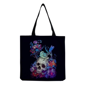 Detail of colorful skull and bird illustration printed on a black canvas tote bag