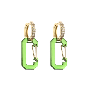 Detail of gold huggie earrings with micro-paved zircons and green carabiner pendants