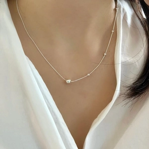 Detailed view of minimalist 925 silver beaded necklace worn on neck for a chic look