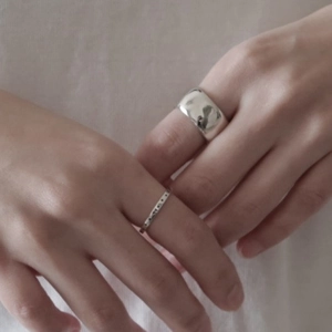Close-up of minimalist 925 sterling silver star rings set worn on a model's hand