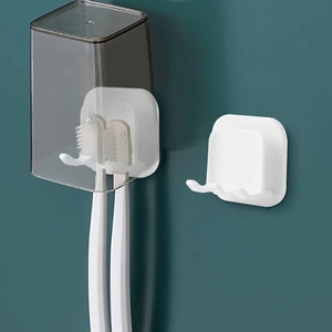 Japanese style wall-mounted white toothbrush holder with grey cups in minimalist bathroom