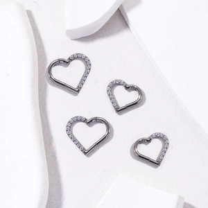 Titanium heart-shaped cartilage earrings with cubic zirconia inlay on polished silver rings