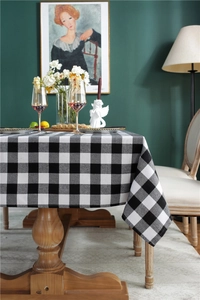 Macro detail of high-density buffalo plaid tablecloth with smooth edge drape on wood table