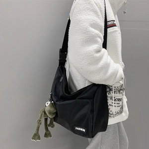 Black canvas messenger bag for men and women with FASHION label and frog charm