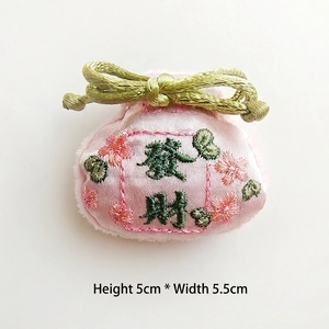 Detail of pink embroidered silk pouch brooch with green tassel and Chinese text, 5x5.5cm