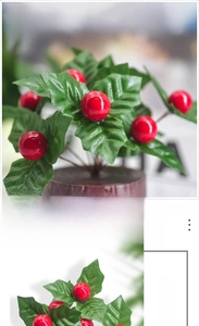 Close-up of artificial Christmas red berries with green leaves on a round wooden base
