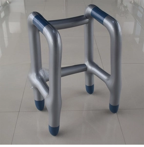 Detailed view of an inflatable PVC walker prop in silver gray with blue grip handles