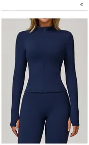 Front view of badge blue zip-up yoga jacket featuring standing collar and thumbholes