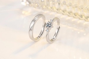 Exquisite silver couple rings set with brilliant stones on a warm aesthetic background