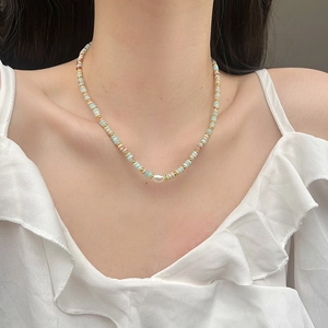 Handmade beaded necklace with natural stones, pearls and colorful glass on a female model