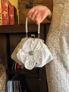Elegant white satin 3D flower handbag with pearl handle and rhinestone center detail
