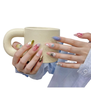 Handmade almond press-on nails with black butterfly, gradient pink and floral art