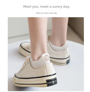 Close-up of cute rabbit and flower embroidery on cotton ankle socks with canvas shoes