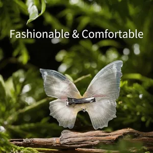 Gradient blue tulle butterfly hair clip on a natural wood branch with greenery